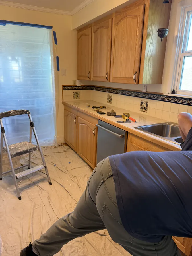 Kitchen countertop work area prepared with tools and protective floor coverings