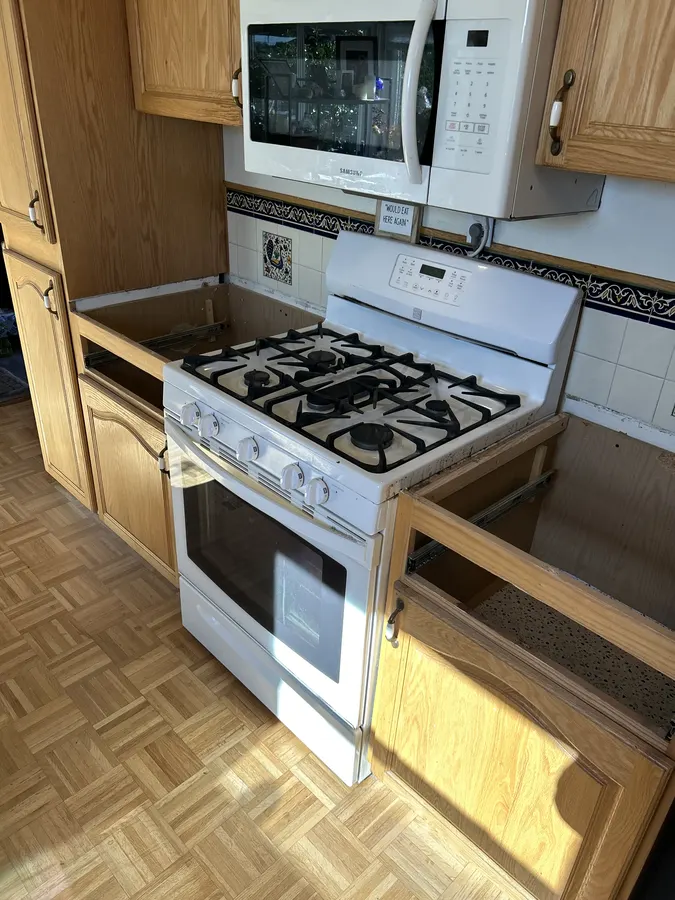Kitchen range area with the existing countertops removed before quartz installation