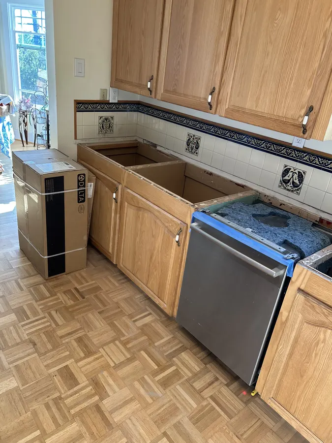 Kitchen sink area with the existing countertop and sink removed before installation