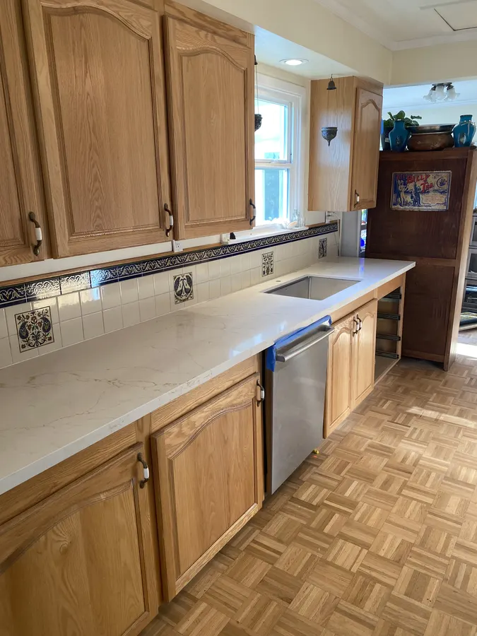 Finished quartz countertop with a new undermount stainless sink and dishwasher